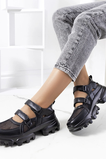 Zwarte sneakers op een... 2