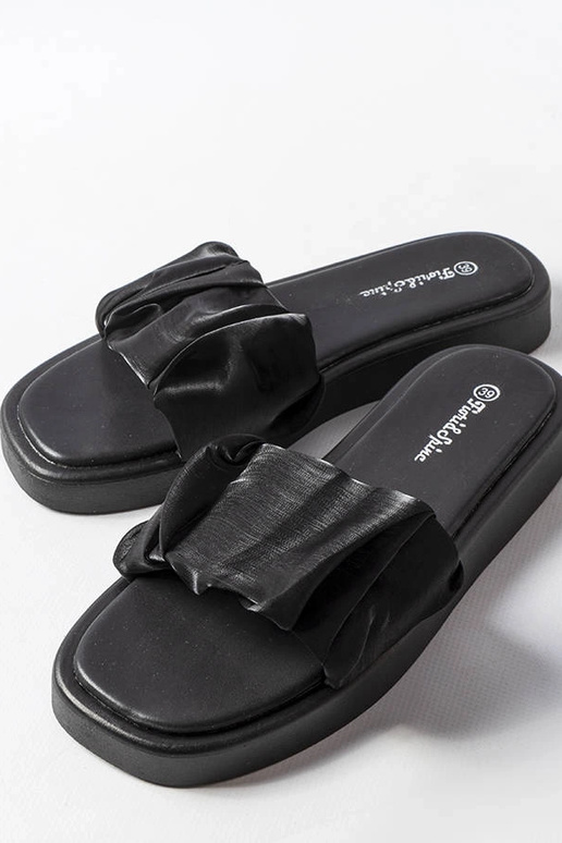 Schwarze Flip-Flops mit Rüschen...