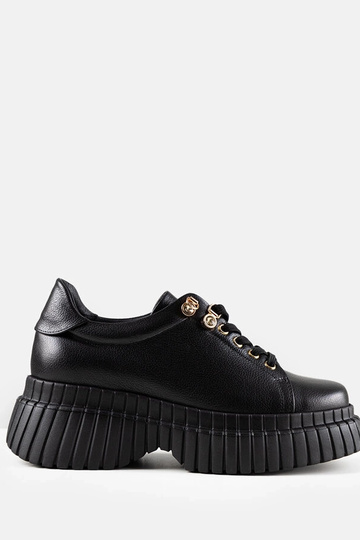 Zwarte leren sneakers op...