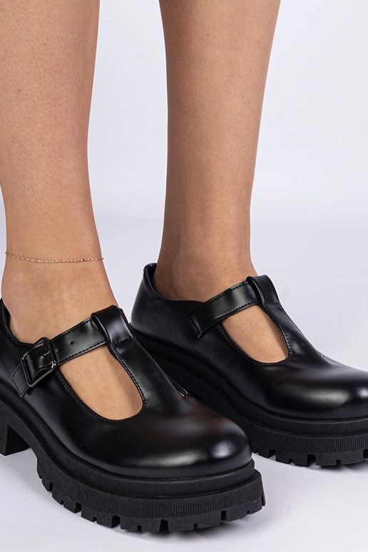 Zwarte instapschoenen op een platform...