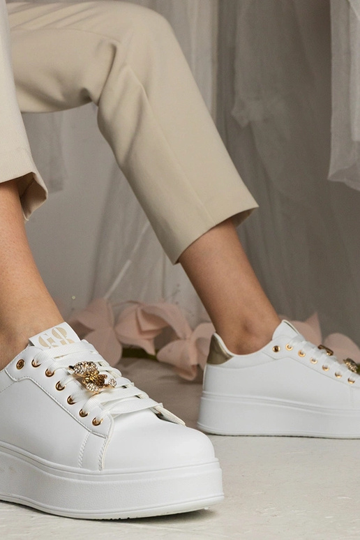 Weiß-goldene Damen Sneakers mit... Weiß-goldene Damen Sneakers mit...