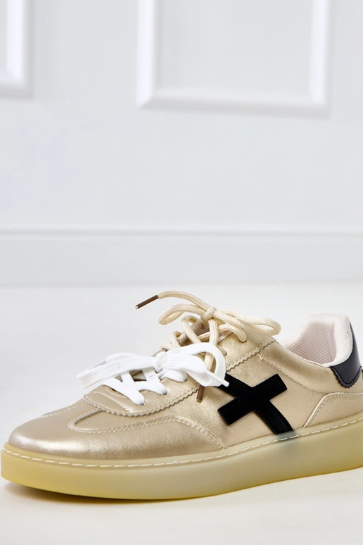 Gouden sneakers op platform met... Gouden sneakers op platform met...