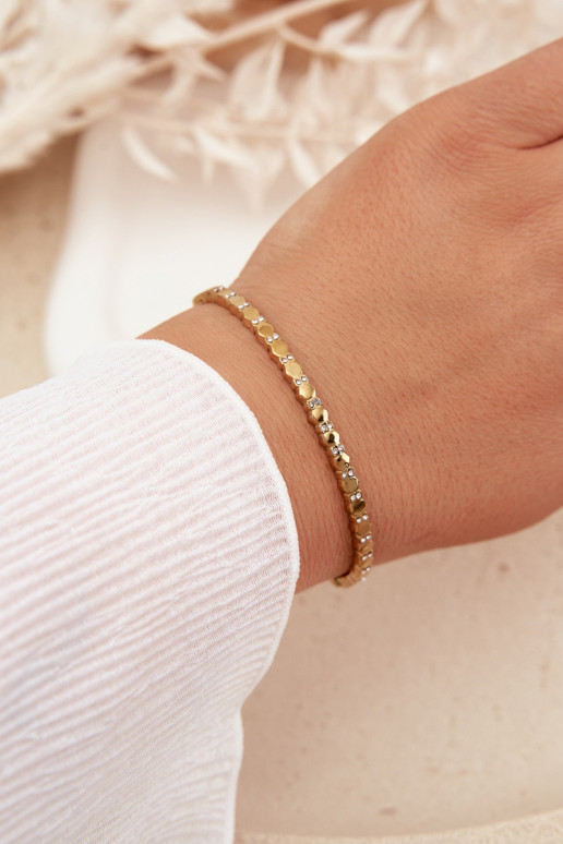 Un bracelet FémininPetitmet des zircons Stal NierdzeÀna couleur dorée