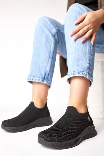 Schwarze textile Slip-On...