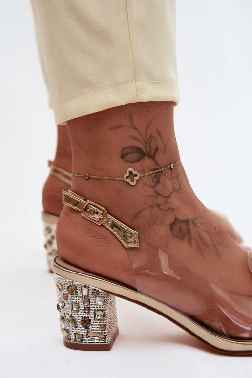 Goldene transparente Sandalen mit Absätzen und funkelnden Nieten D&A